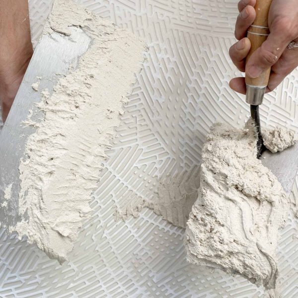 notched-trowel-worker-hands-tile